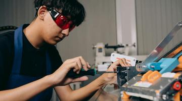 Engineering apprentice with a screwdriver